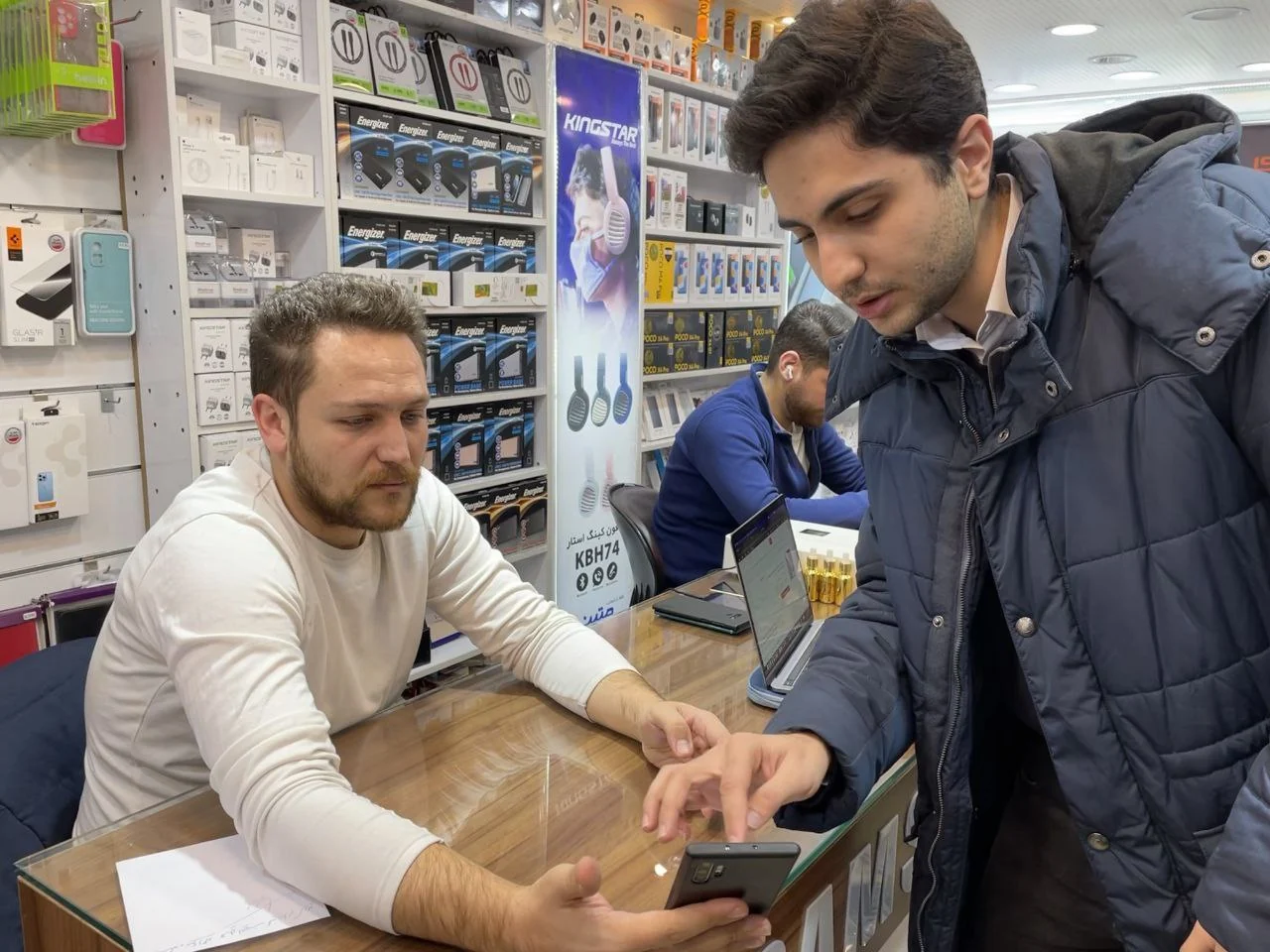 Testing the panel with a seller at his phone accessories counter