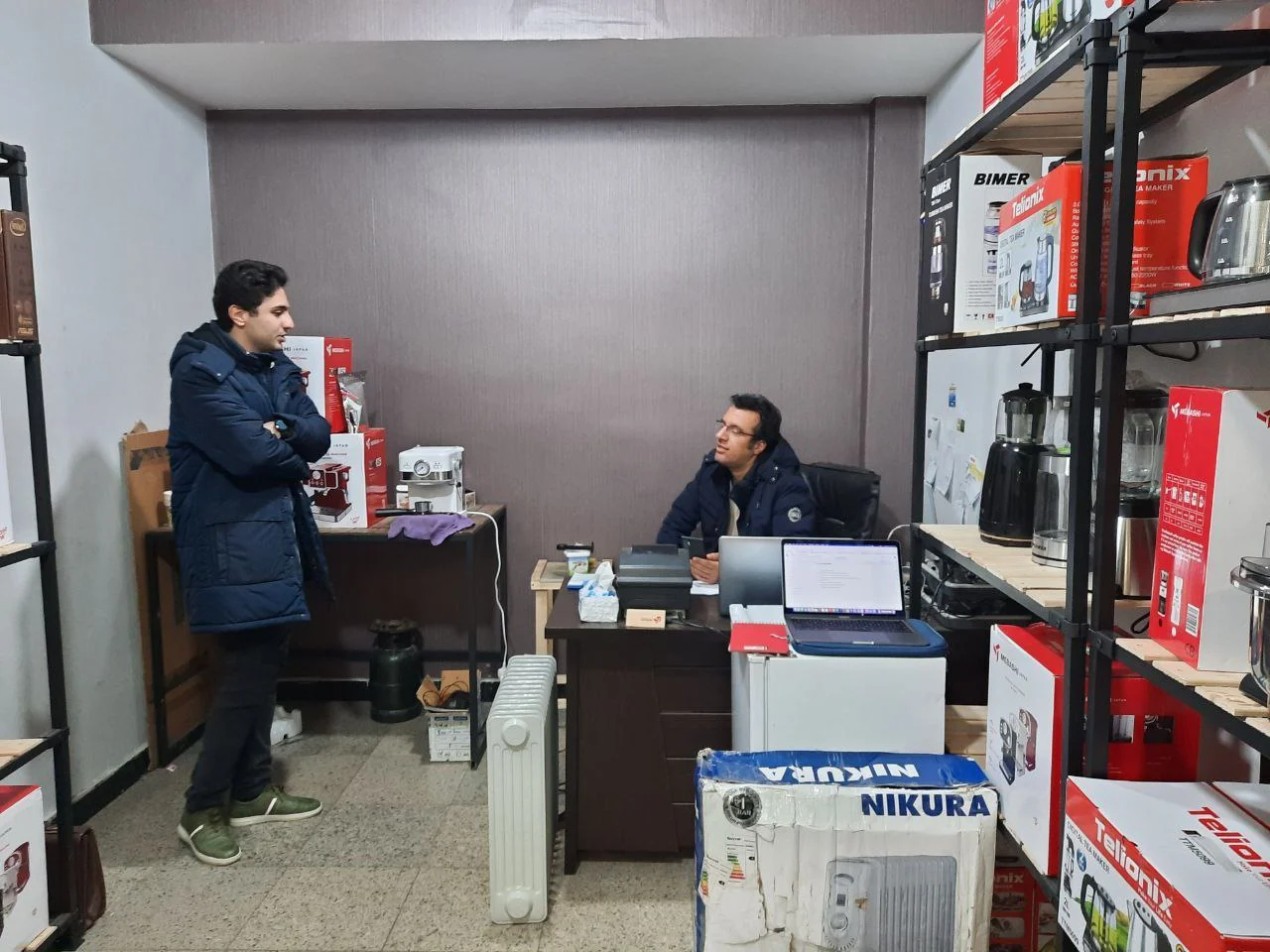 Interviewing a home appliance wholesaler in his stockroom office